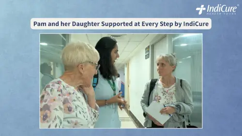 Pamela Scaddan and her daughter speaking with an IndiCure health coordinator in a hospital corridor in India.